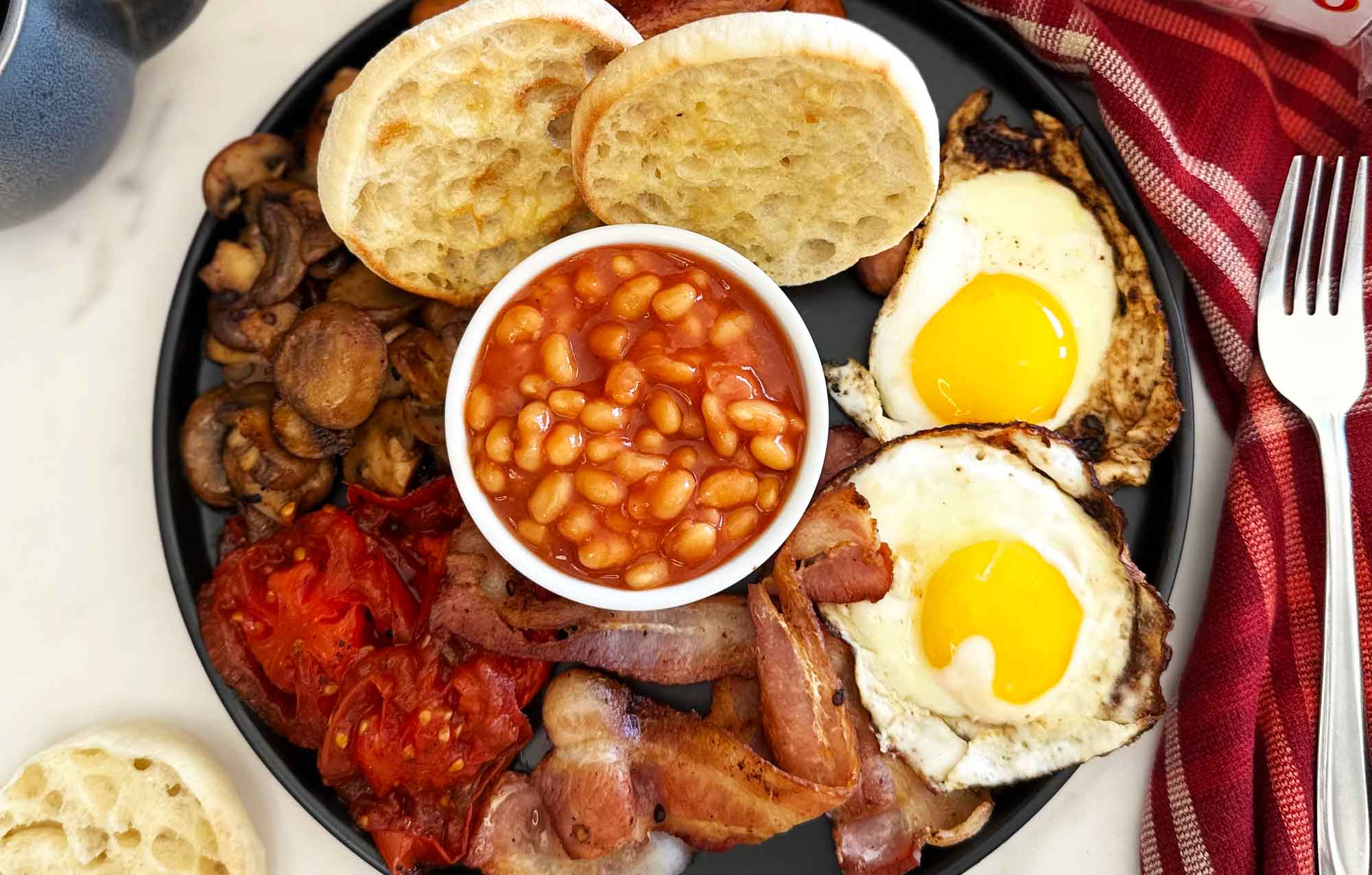 BAYS ON A TRAY WITH BEANS TOMATO EGGS BACON AND MUSHROOMS