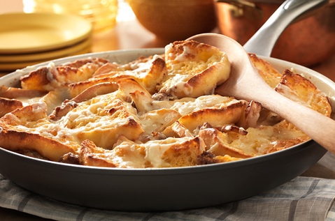 A PAN FILLED WITH BAYS ENGLISH MUFFINS, MEAT, AND MELTED CHEESE